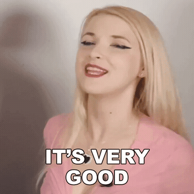 Blonde Woman In Pink Shirt Smiling Saying Very Good GIF