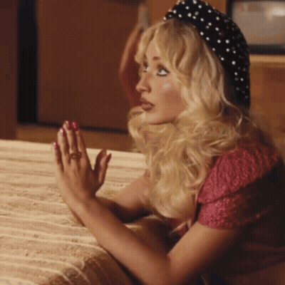 Blonde Woman In Polka Dot Hat And Red Top GIF
