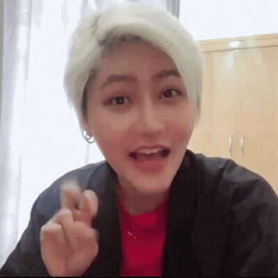 Blonde Woman In Red And Black Making Heart GIF