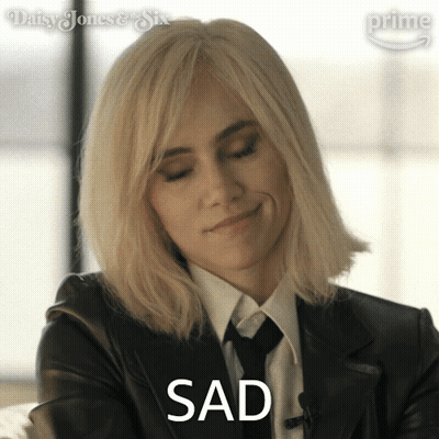 Blonde Woman In Suit And Tie Says Sad GIF
