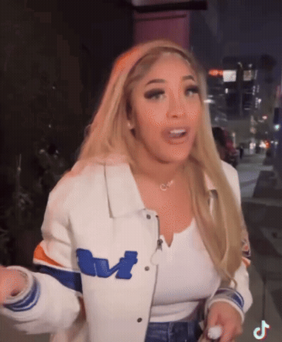 Blonde Woman In White Jacket With Letter M GIF