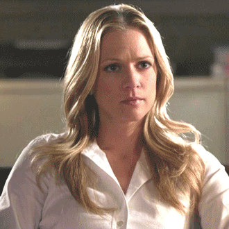 Blonde Woman In White Shirt Looking At Camera GIF