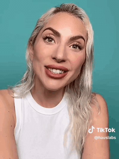 Blonde Woman In White Tank Top Smiling GIF