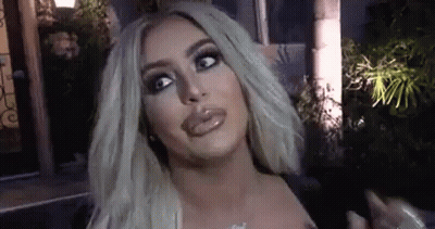 Blonde Woman Making Funny Face In Front Of Building GIF