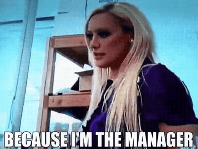 Blonde Woman Saying Because I'm The Manager In Front Of Shelf GIF