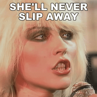 Blonde Woman Singing Into Microphone She'll Never Slip Away GIF