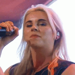 Blonde Woman Singing Into Microphone With Ring GIF