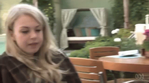 Blonde Woman Sitting At Table GIF