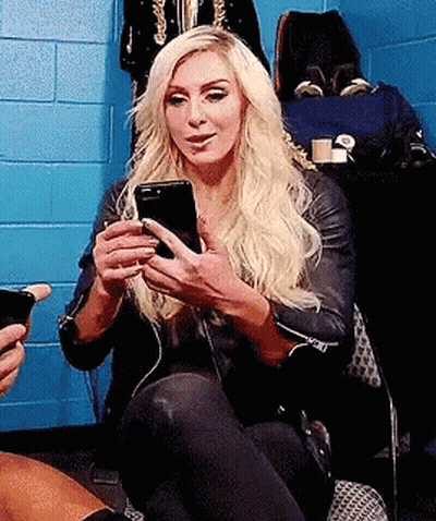 Blonde Woman Sitting In Chair Holding Cell Phone GIF
