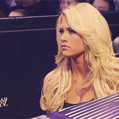 Blonde Woman Sitting In Front Of Wrestling Ring GIF