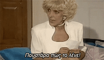 Blonde Woman Sitting On Bed With Foreign Language Above GIF