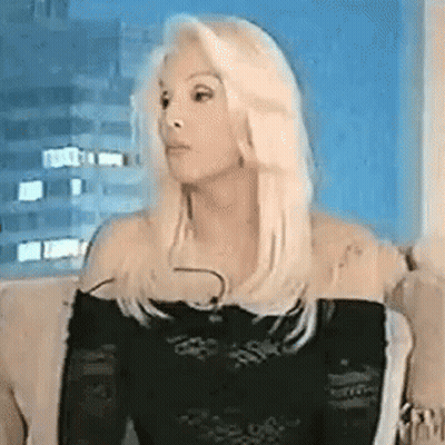 Blonde Woman Sitting On Couch In Black Top GIF