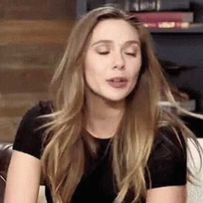Blonde Woman Sitting On Couch Making Funny Face GIF