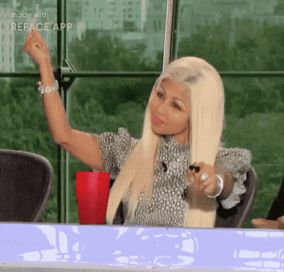 Blonde Woman Sitting With Fist In Air GIF