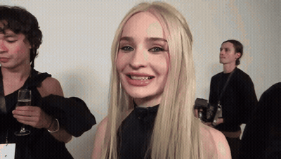 Blonde Woman Smiling Holding Glass Of Wine GIF
