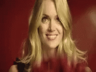 Blonde Woman Smiling Holding Red Heart GIF