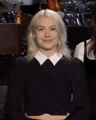 Blonde Woman Smiling In Black Shirt And White Collar GIF