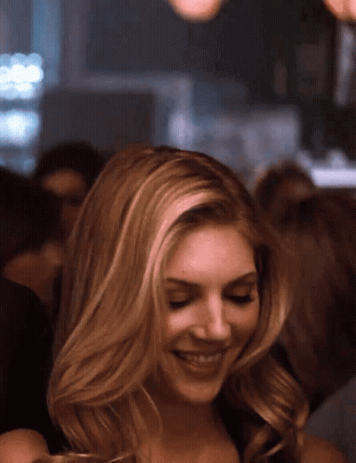 Blonde Woman Smiling In Crowd GIF