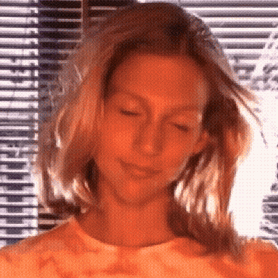 Blonde Woman Standing By Window GIF