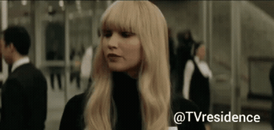 Blonde Woman Standing In Front Of Glass Wall GIF