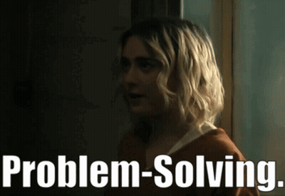 Blonde Woman Standing in Front of Problem-Solving Sign