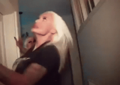 Blonde Woman Standing In Hallway GIF