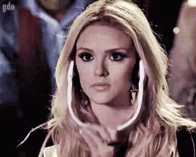 Blonde Woman Wearing Headphones Looking At Camera GIF