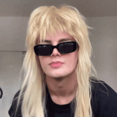 Blonde Woman Wearing Sunglasses and Mullet Wig