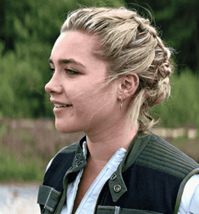 Blonde Woman With Braided Bun And Earrings GIF