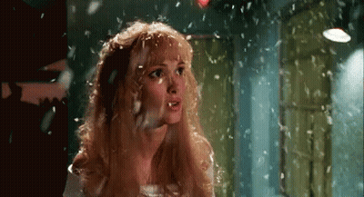 Blonde Woman With Feathers Falling On Head GIF