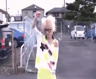 Blonde Woman With Glasses Hand Up In Parking Lot GIF