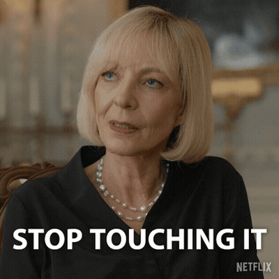 Blonde Woman With Pearl Necklace At Stop Touching It Sign GIF