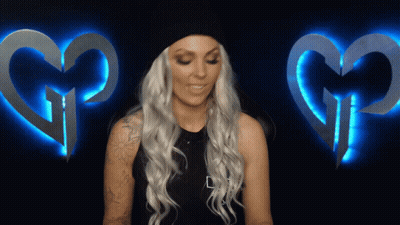 Blonde Woman With Tattoo And Two Glowing Hearts GIF