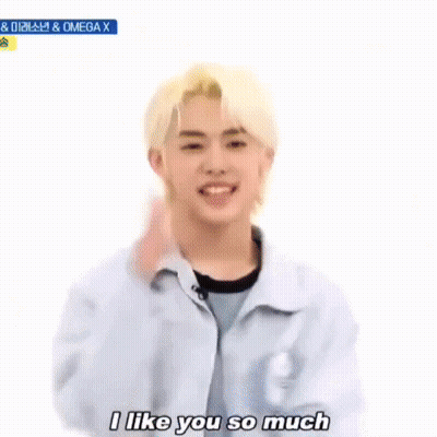 Blonde Young Man Making Heart With Hands
