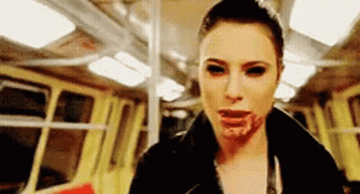 Bloody-Faced Woman Black Eyes Riding Train GIF