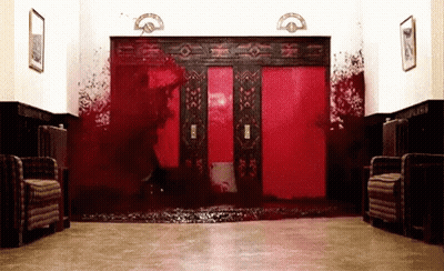 Bloody Hallway With Red Elevator And Chairs GIF