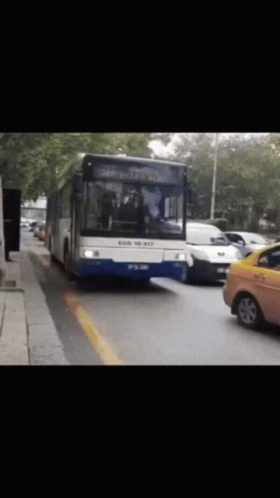 Blue And White Bus Driving Down Road GIF
