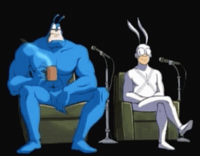 Blue And White Cartoon Characters Sitting At Microphones GIF