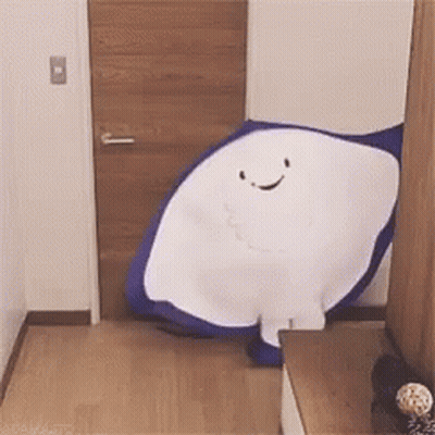 Blue And White Stuffed Animal Smiling In Hallway GIF