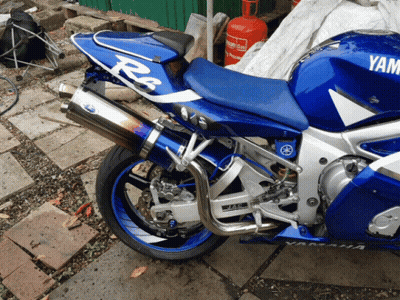 Blue And White Yamaha Motorcycle Parked Outside GIF