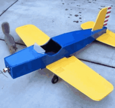 Blue And Yellow Model Airplane On Concrete GIF