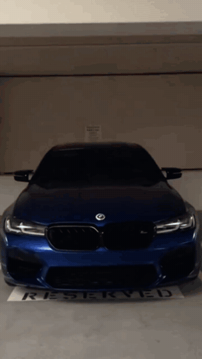 Blue BMW Parked In Reserved Parking Lot GIF