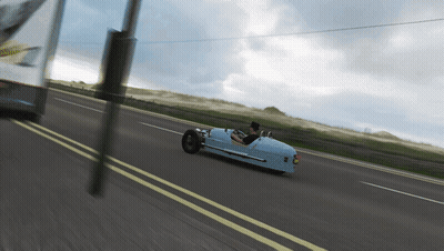 Blue Car Driving on Road With Yellow Line
