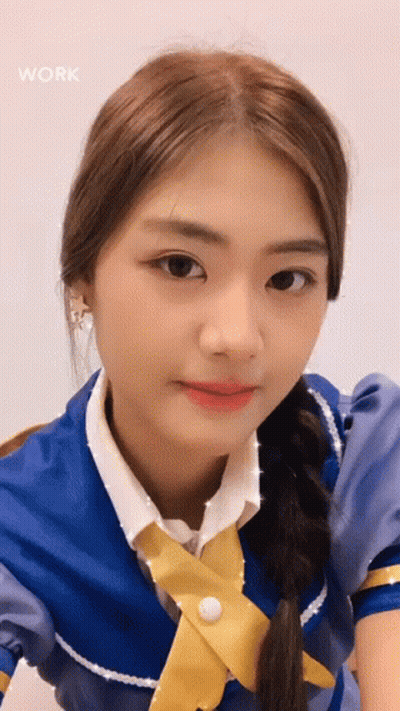 Blue Dress Yellow Tie Girl Looking At Camera GIF