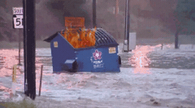 Blue Dumpster Floating In Flooded Area With 5 Sign GIF