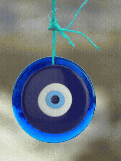 Blue Evil Eye Hanging From String GIF
