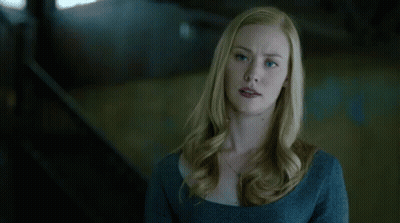 Blue-Eyed Blonde Woman In Blue Sweater And Necklace GIF