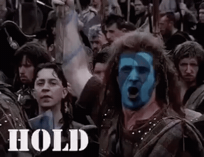 Blue-Faced Man Surrounded By Sword Crowd GIF