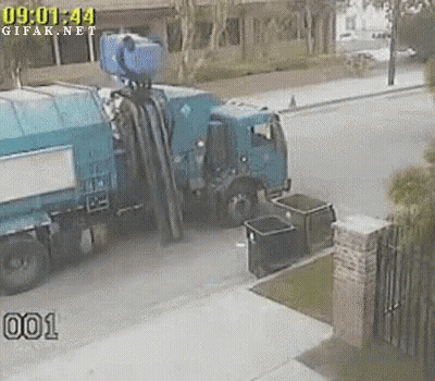 Blue Garbage Truck Parked In Front Of House GIF
