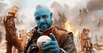 Blue-Haired Bearded Man Holding Light Bulb Thumbs Up GIF